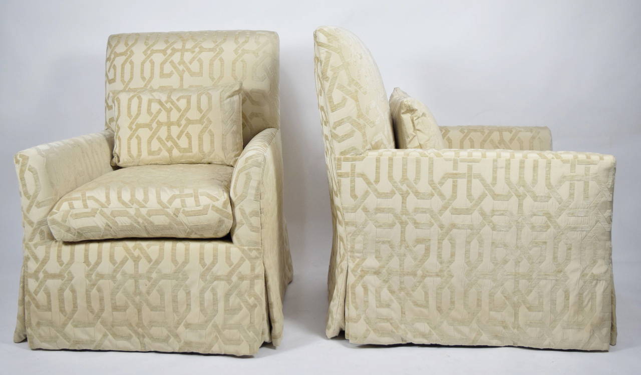 A pair of lounge chairs in the style of R Jones 