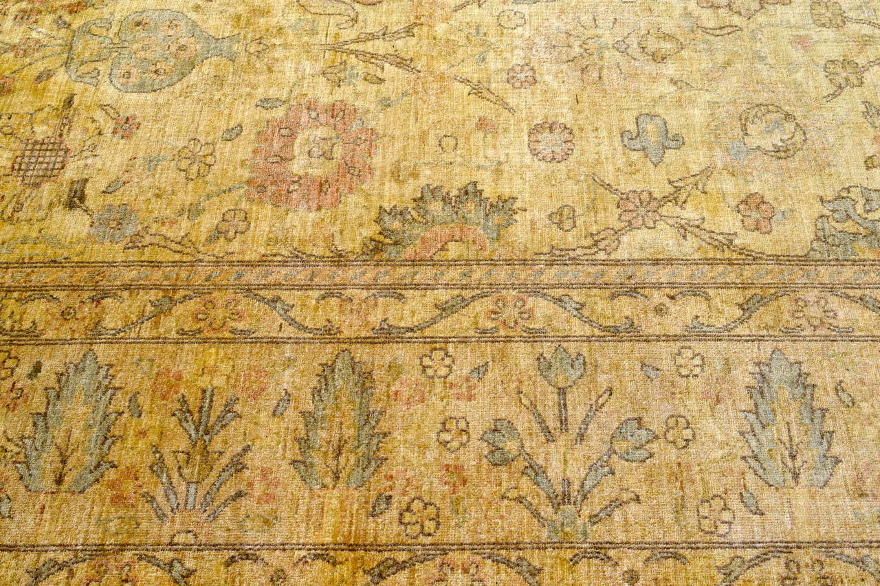 Beautiful Persian Sultanabad rug in carmels and blues. Rug is in very nice condition. Photos show unevenness in lighting.