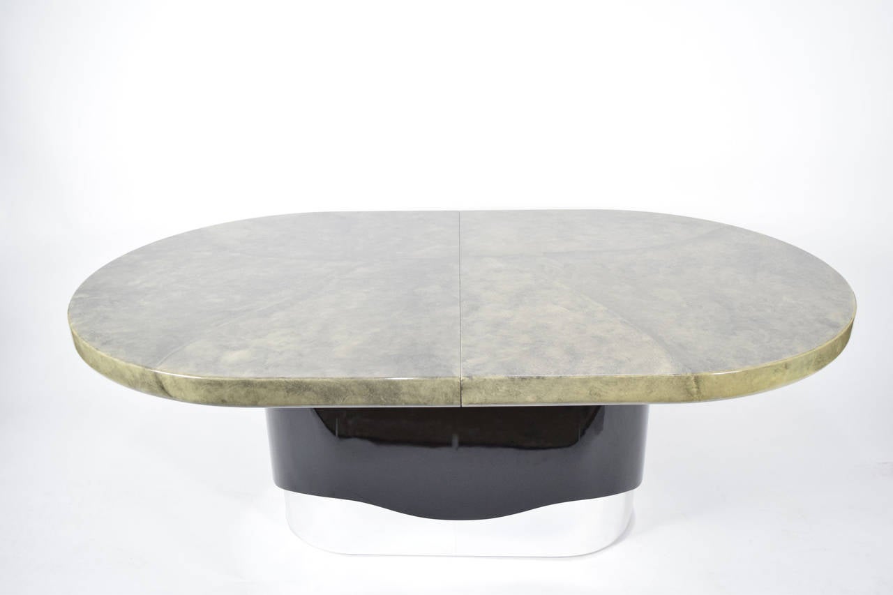 Cantoni high-gloss lacquer faux goatskin dining table. Black base with a polished stainless steel base. See matching sideboard/buffet. Table has two 18