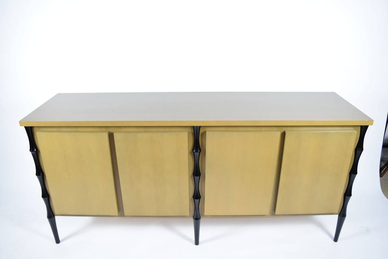 Beautiful Donghia inspired sideboard. Suttle bamboo style legs, four doors. Beautiful stain finish on wood.