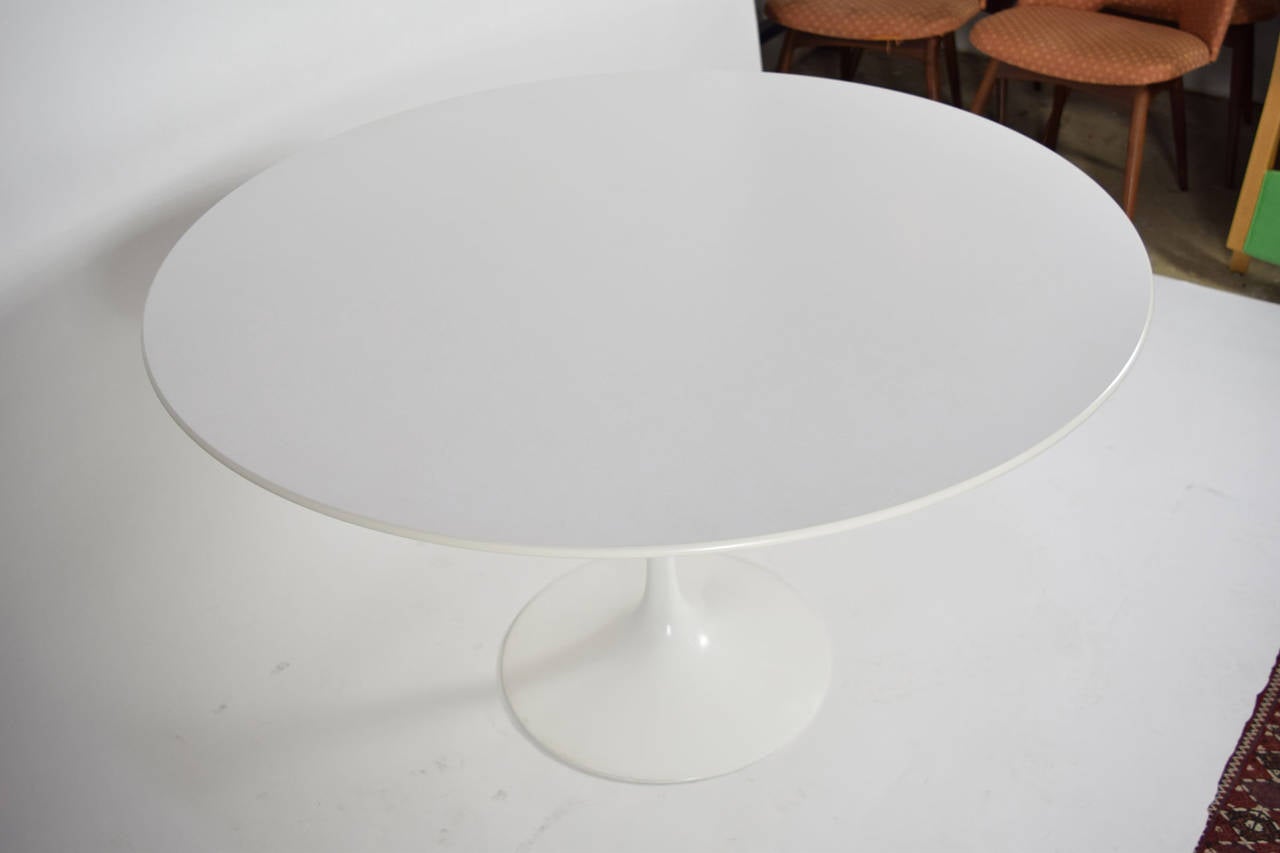 Like new Eero Saarinen tulip table with cast aluminum base and white laminate top. Stamped Knoll Productions on base.