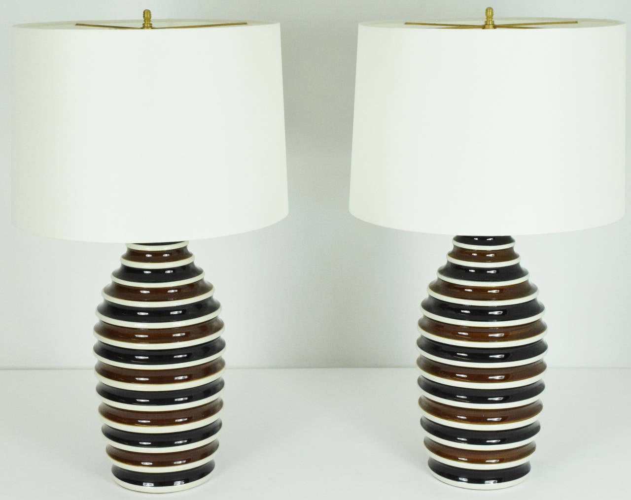 A beautiful pair of Morris Greenspan ceramic lamps in black, brown and white. Price excludes shades.