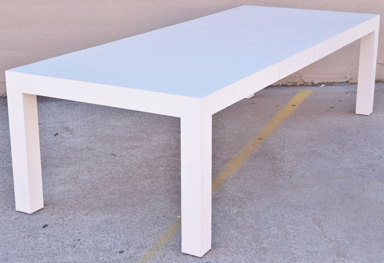 Beautiful white laminate parsons style dining table by Milo Baughman for Thayer-Coggin. Table has two 20