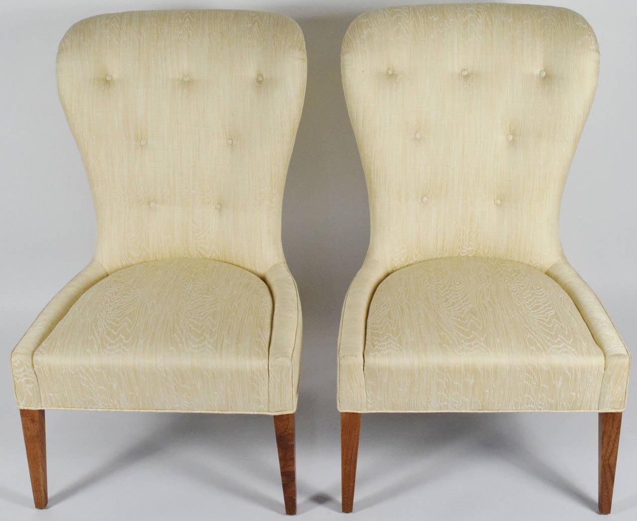 This is an elegant pair of chairs upholstered in a softly patterned silk and linen.  Very clean lined and simple, fits in any environment. 