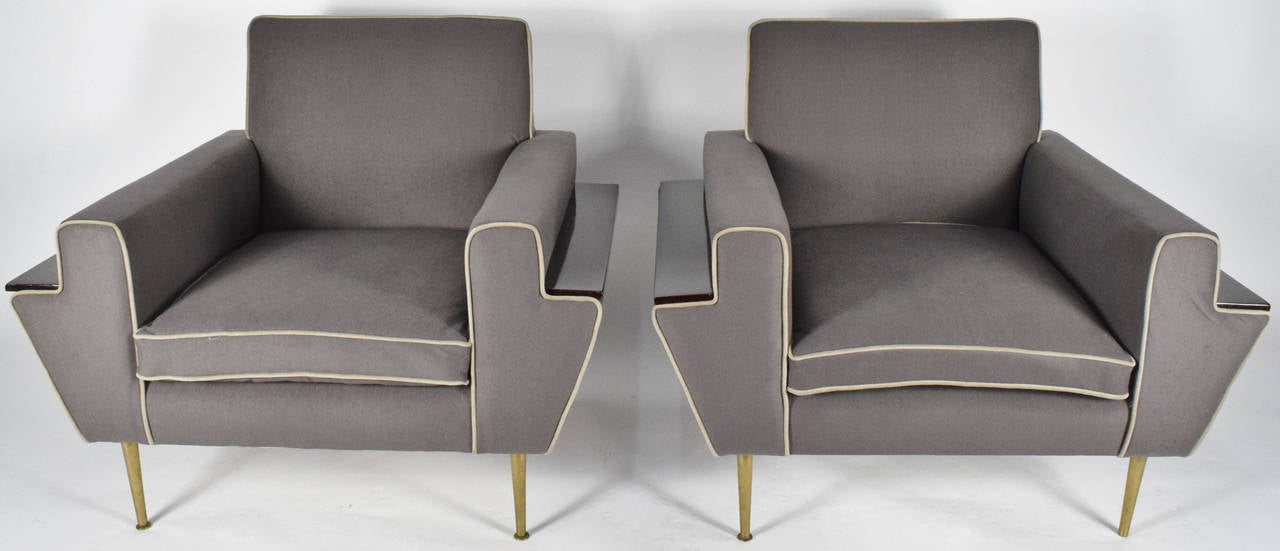 This is a beautiful pair of unique Italian lounge chairs. The have brass legs and have a wood plank on the side of each arm for a drink rest!
