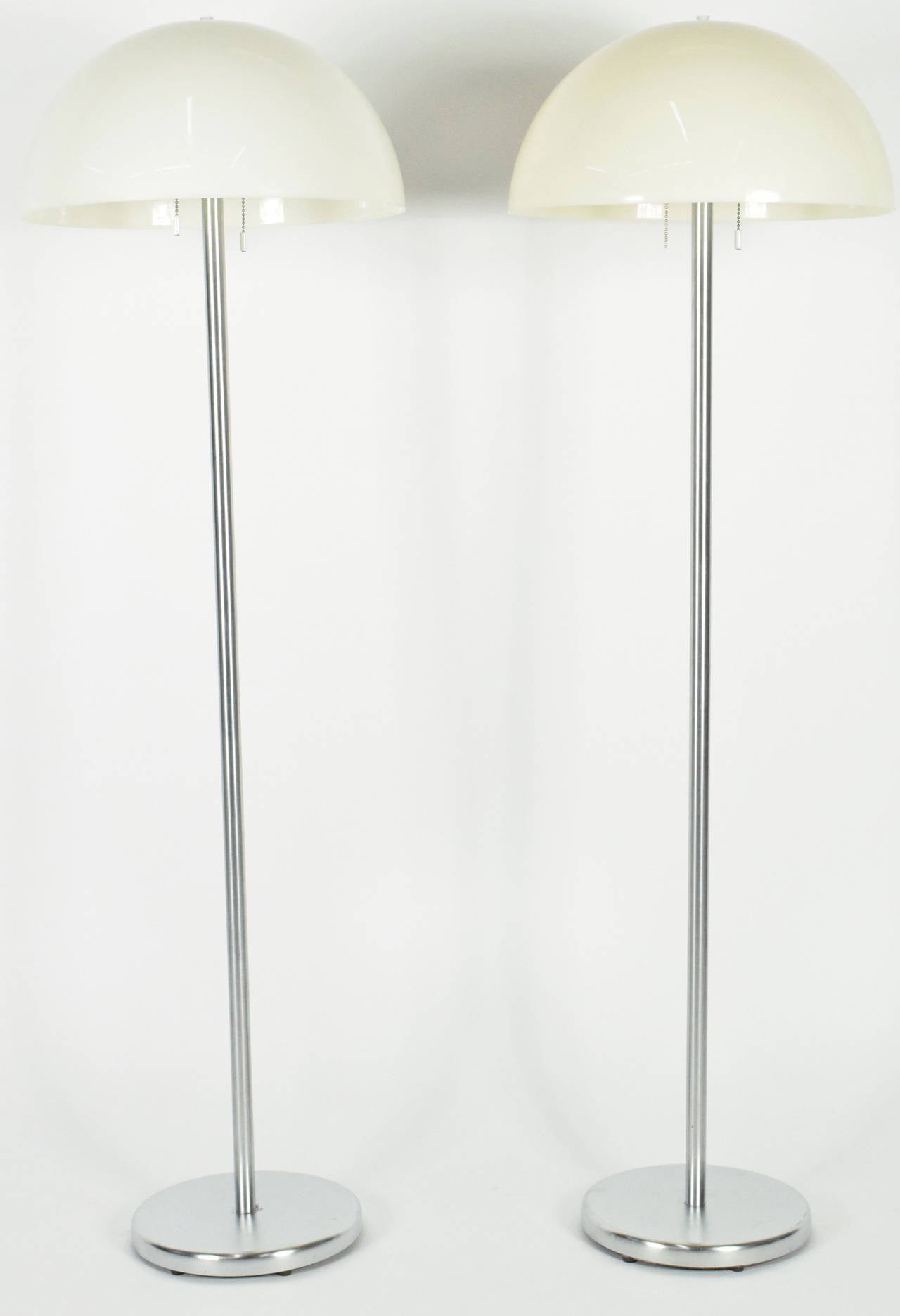 Very nice pair of floor lamps with chrome base and acrylic mushroom shape shade, by Nessen Studio.