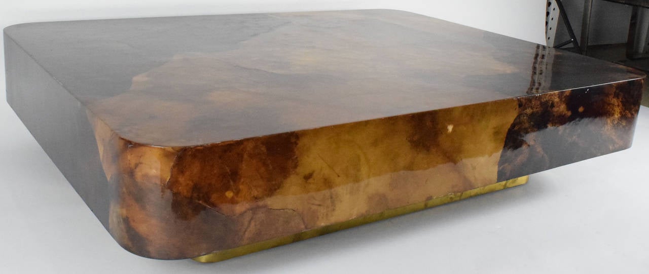 This is a gorgeous goatskin coffee table by Karl Springer. It has a brass finish base.