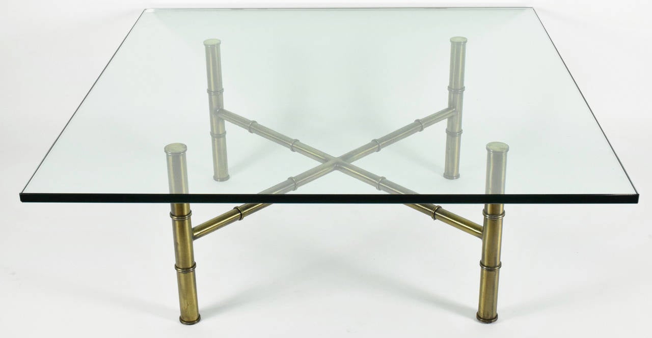 This is a beautiful coffee table in an antiqued faux bamboo brass finish base with thick glass top by Mastercraft. Elegantly simple, works in contemporary or traditional environments.