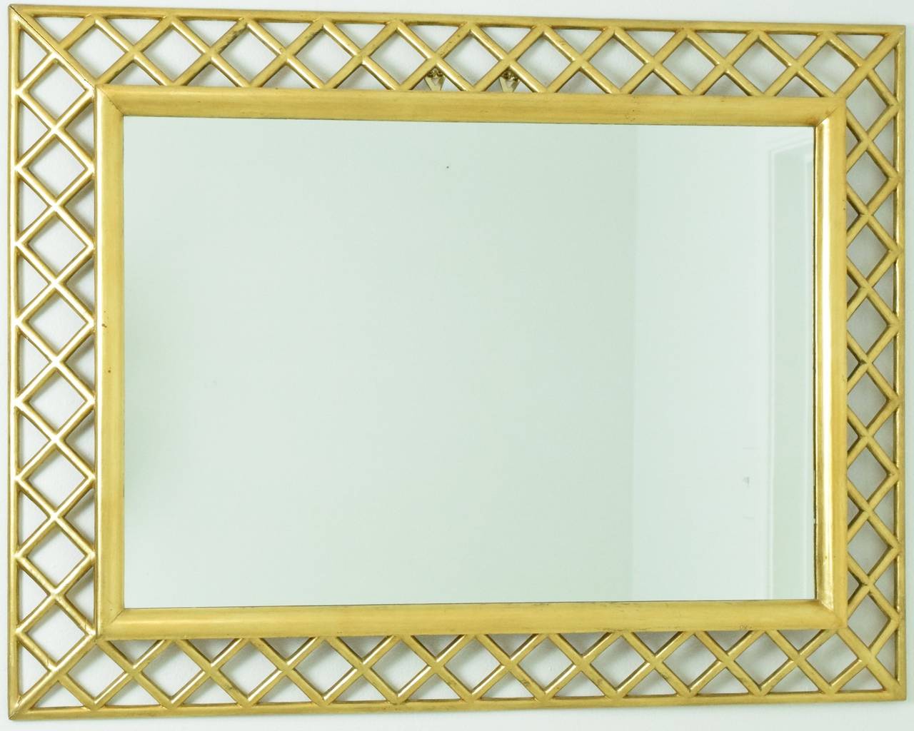 Handsome Italian mirror with giltwood carved lattice frame.