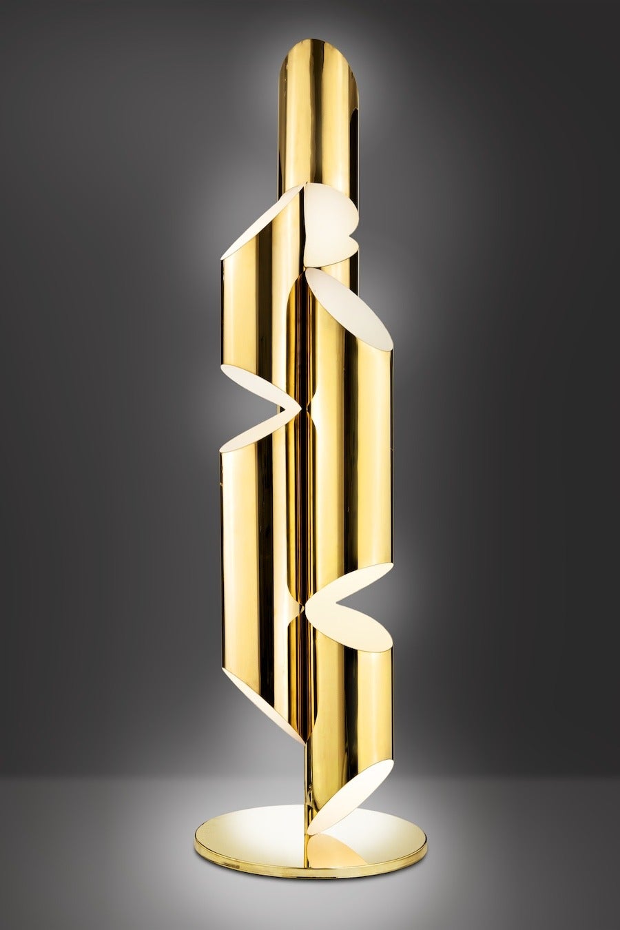 Inspired by church organ pipes, this seven-foot floor lamp or sculpture is fabricated from mirror-polished brass. Incandescent light fills each tube and glows out from strategically placed slits creating a warm and inviting Ambience. Designed in