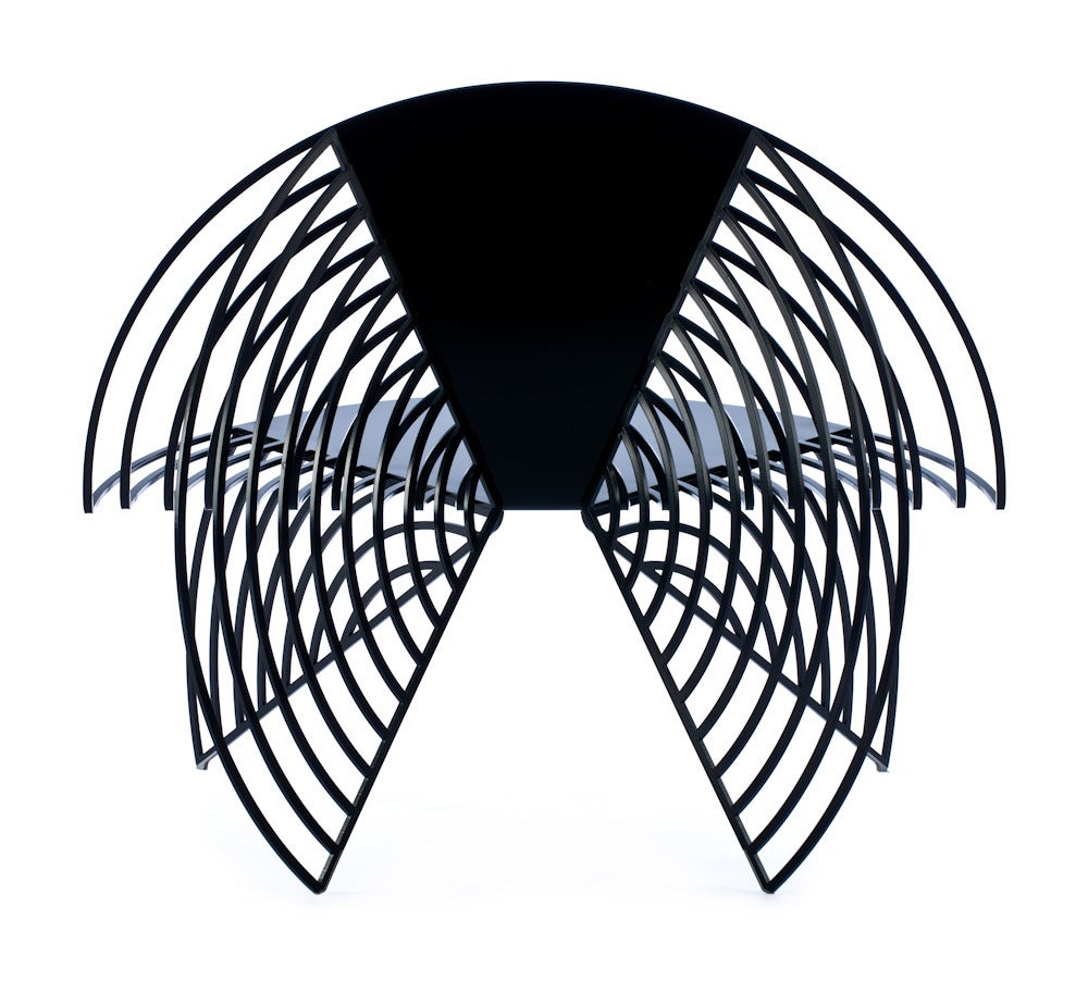 The wings of steel chair is fabricated from laser-cut steel and powder coated in a variety of durable colors for indoor and outdoor use. 

While the material is strong, the form is light as a butterfly about to take flight. Its laser cut strips