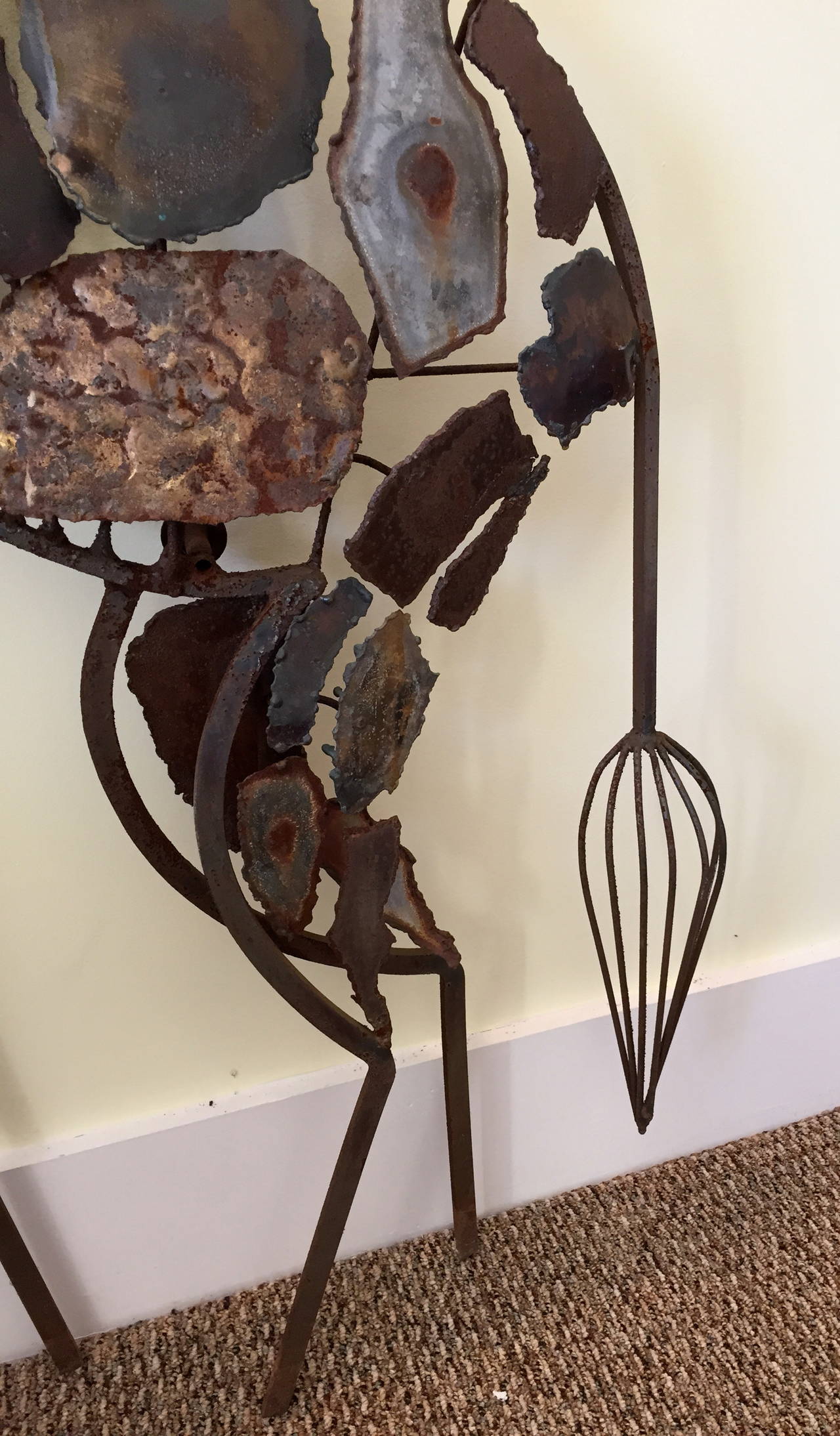 This whimsical Mid-Century giraffe sculpture, handmade with a three-dimensional form of assorted metals, is beautifully executed and is 34"w x 6"d x 76.5"h.

It is in excellent original condition with no breaks or repairs, though it