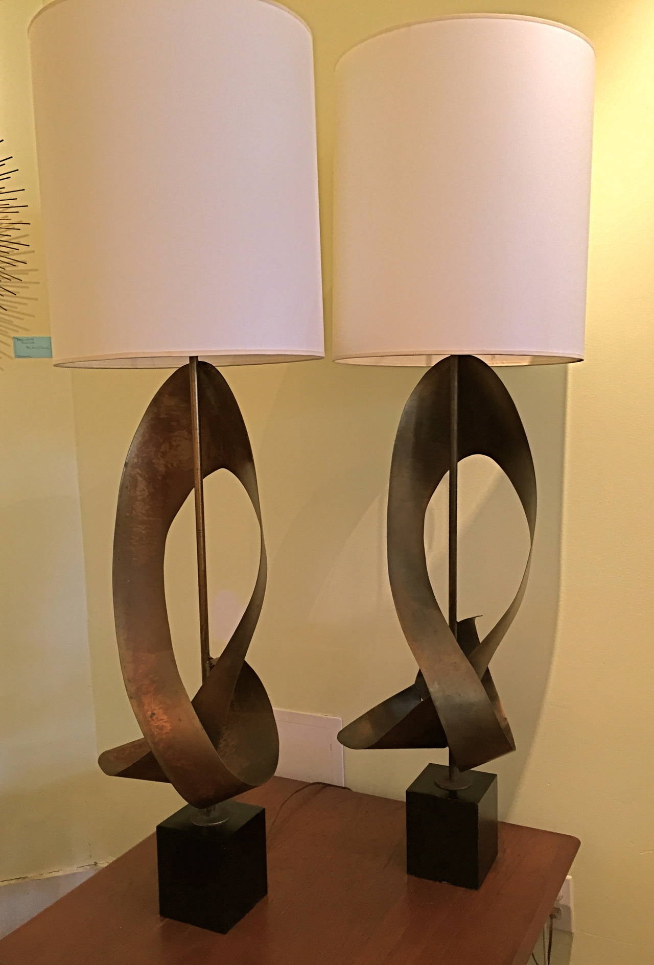 These monumental lamps Stand an impressive 42.5 inches to the top of the original harp, which is included. The sculpture itself is 36 inches high. With the lampshade (new but period appropriate) they soar up to 52 inches high. Being Brutalist in