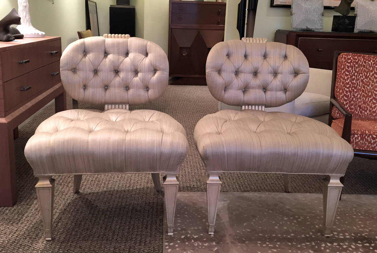 These glamorous slipper chairs are classic Grosfeld House.  Frames are in excellent condition and have a metallic glaze over white.  The tufted upholstery is also in very good condition; the fabric is not original, but does have age.  They could be