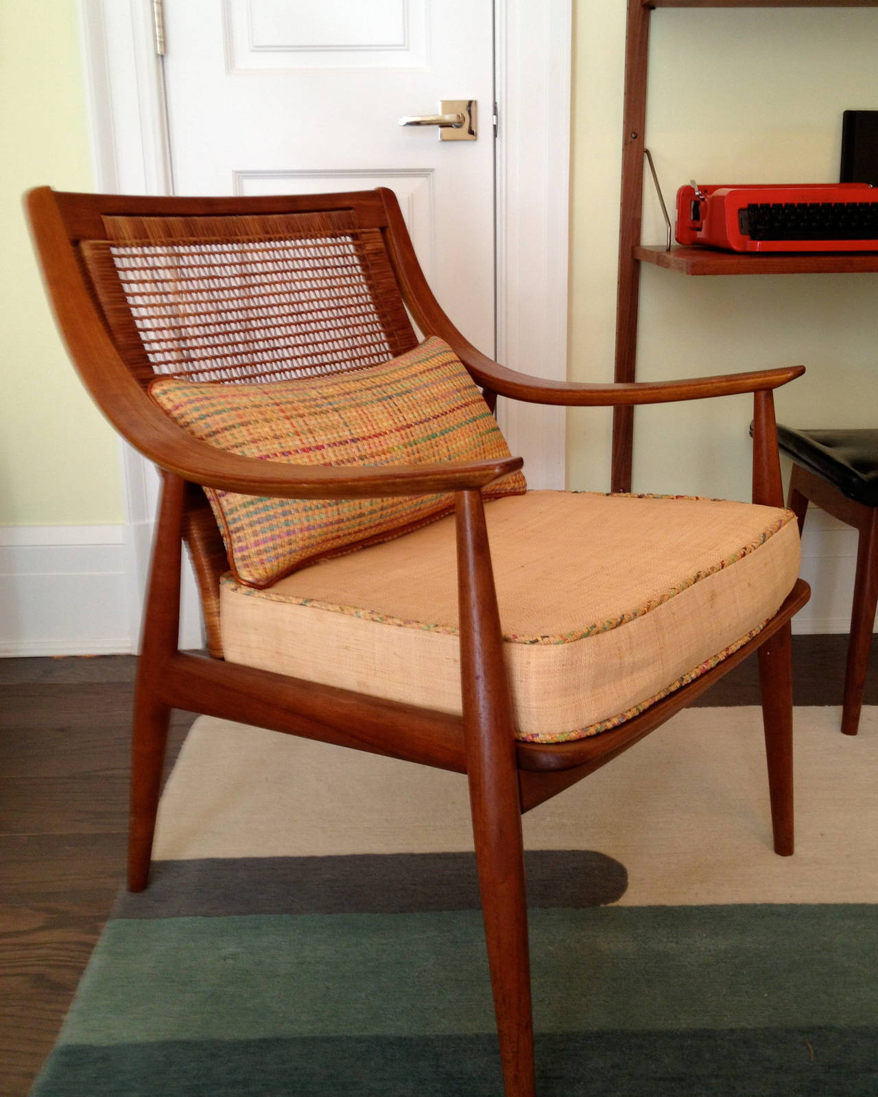 The chair is in excellent original condition, including the cane back.

The seat cushion has been redone and is now covered in natural raffia from Donghia. The lumbar pillow is covered in a raffia from Kravet. The original cushion covers are