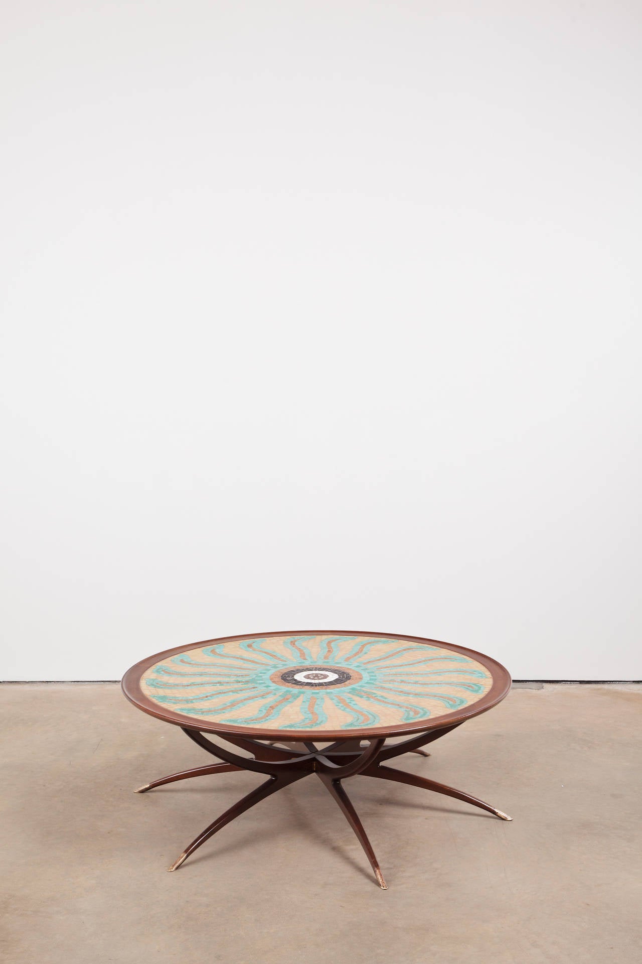 A stunning table with a mosaic pattern of a multi-colored sun