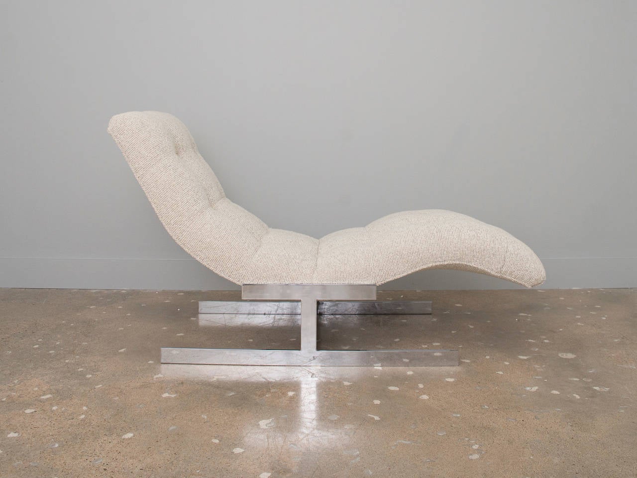 Sculptural wave chaise lounge with chrome base recently reupholstered in creamy Maharam Pebble wool. A gorgeous chaise for any room.