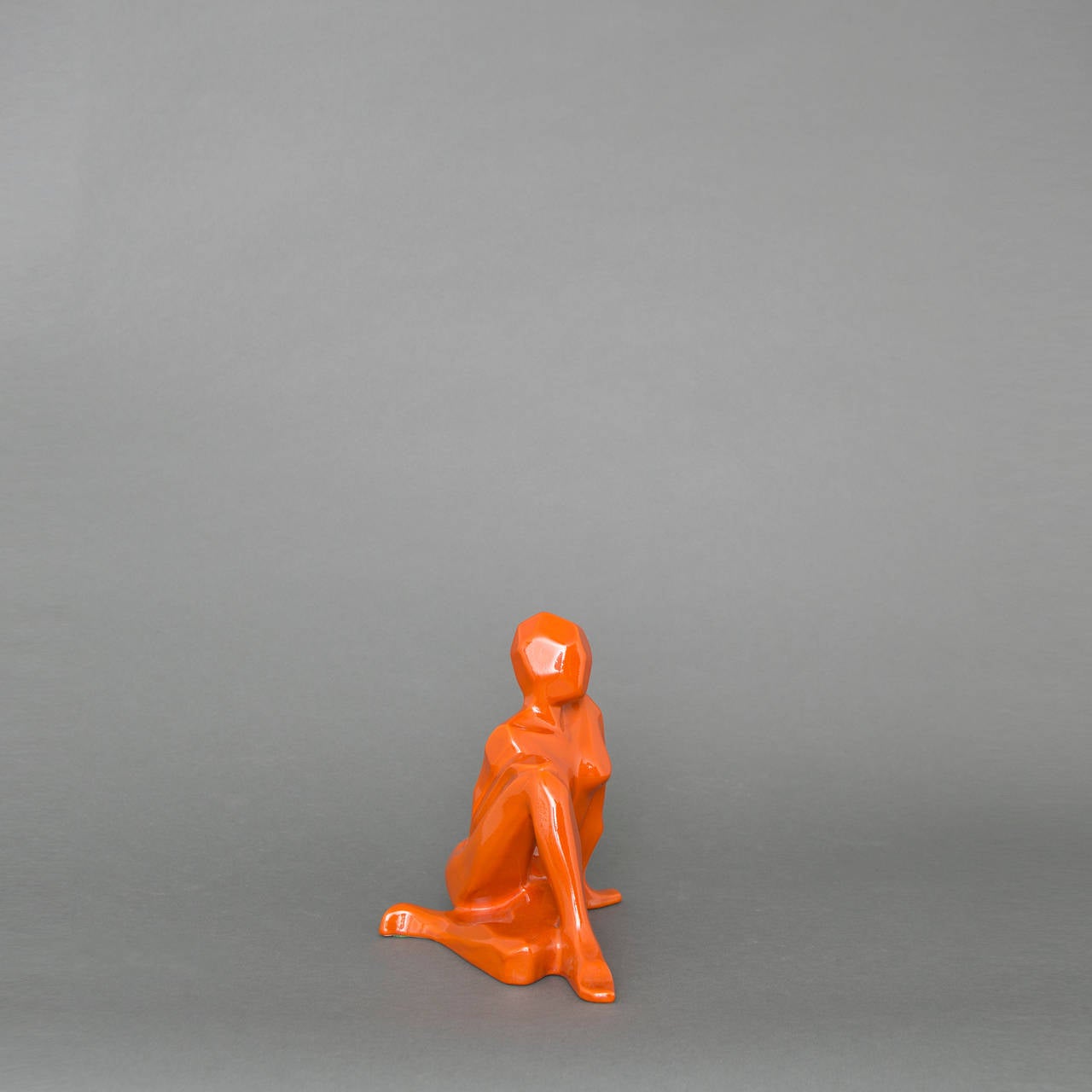 Cubist Jaru female nude sculpture in a rich orange glaze.