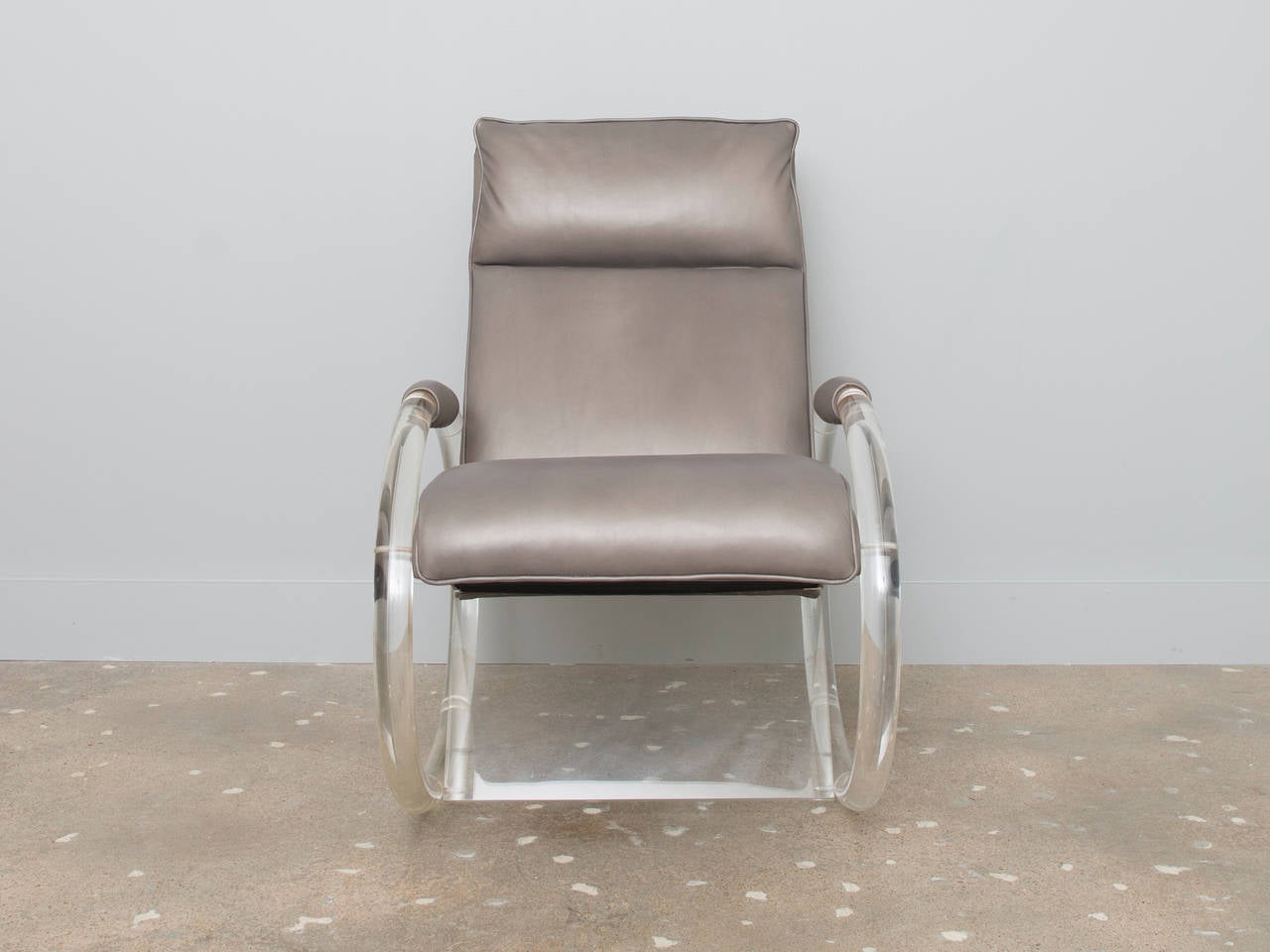 Rocking chair, designed by Charles Hollis Jones, upholstered in slate grey leather with a sculptural lucite base.  The chair is striking and a fine example of the talent that earned Charles Hollis Jones a Smithsonian recognition.