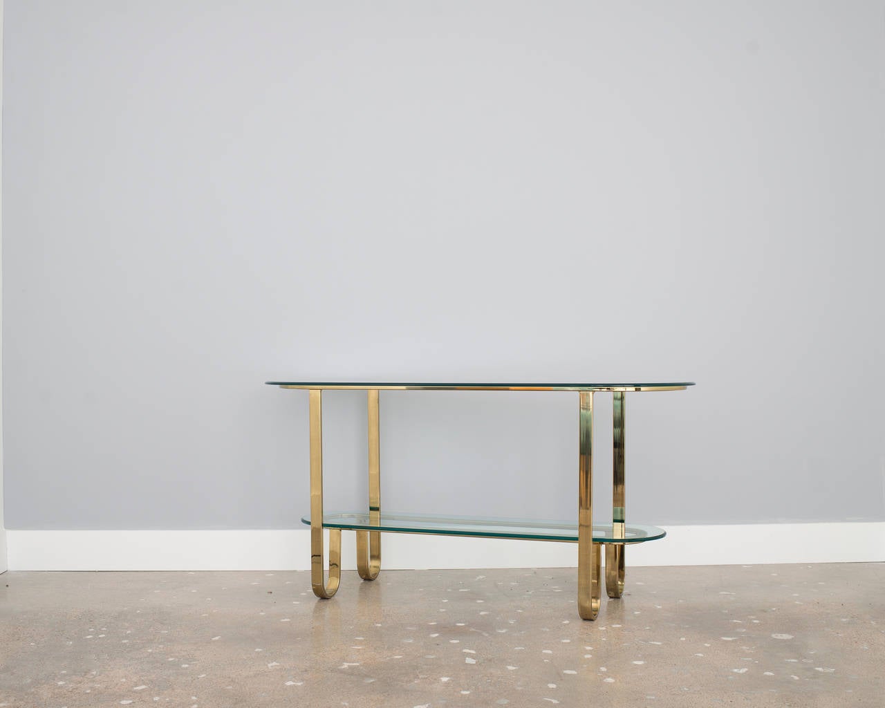 Hall, console or sofa table, brass DIA, sensuous lines, two shelves, racetrack shaped glass.