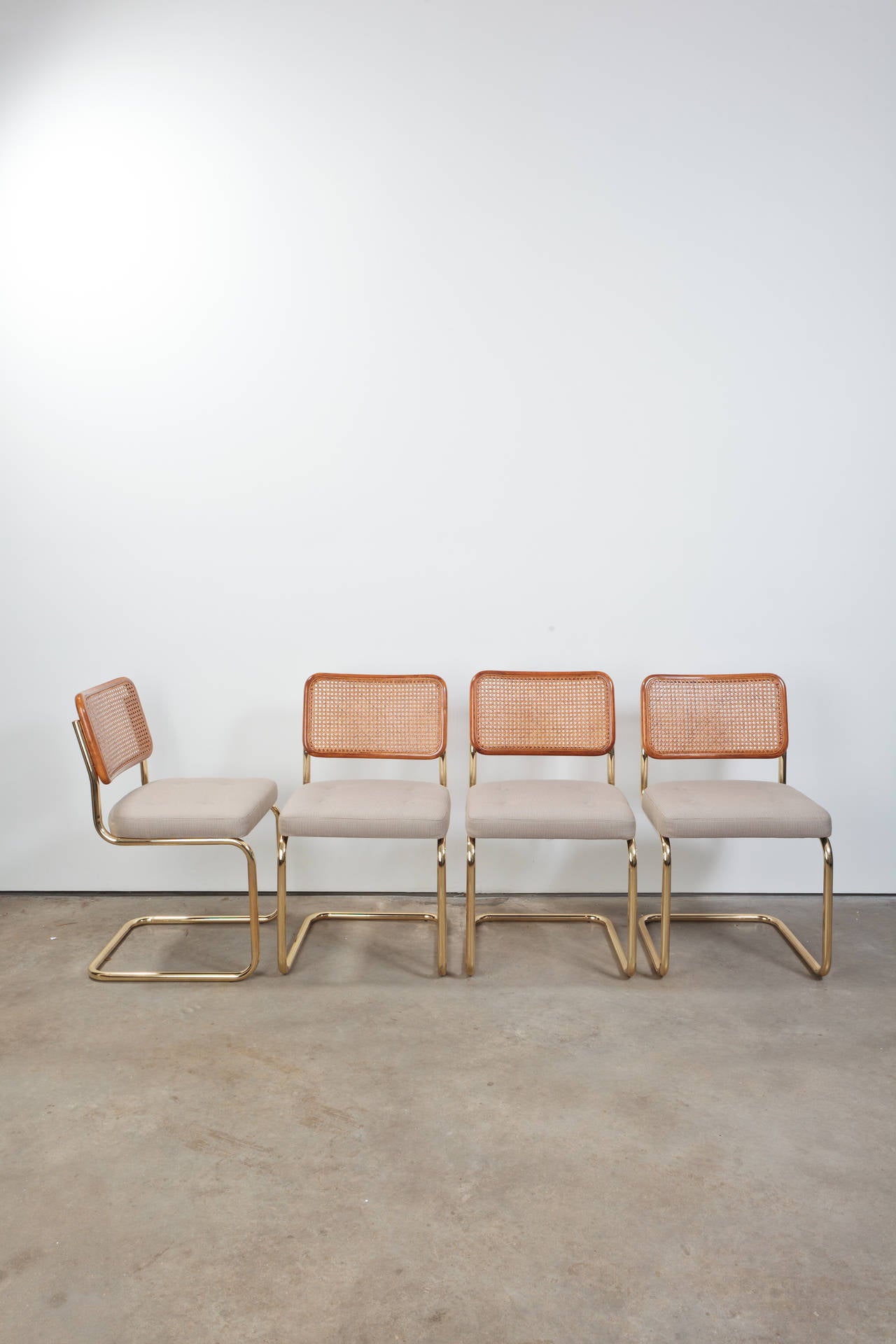 Marcel Breuer Cesca style chairs with upholstered seats and brass frame, in excellent condition and newly upholstered.