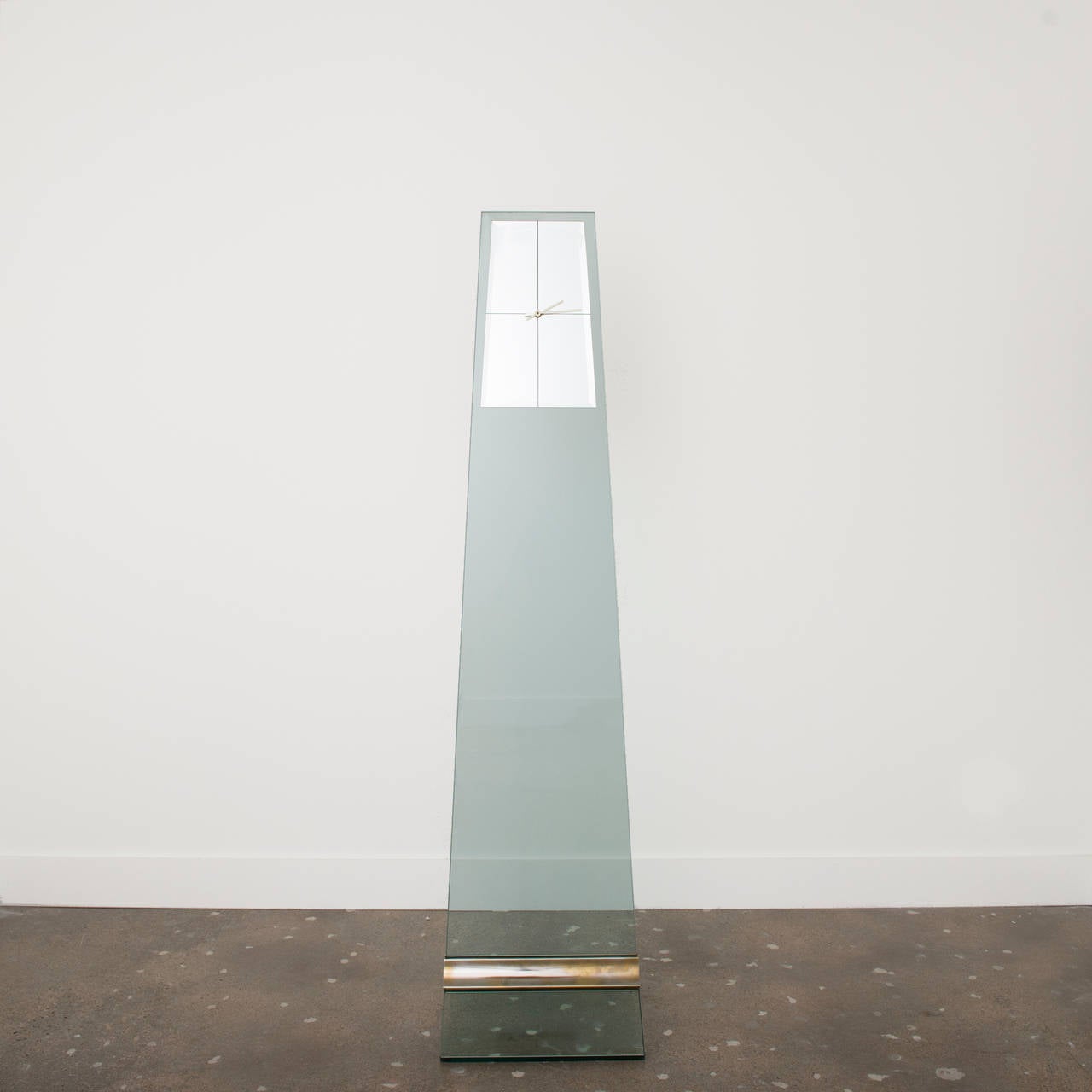 Tall, Modernist glass and steel clock by Pace, circa 1970.  Thick plate glass sections are held together by an ingenious polished steel horizontal wedge.