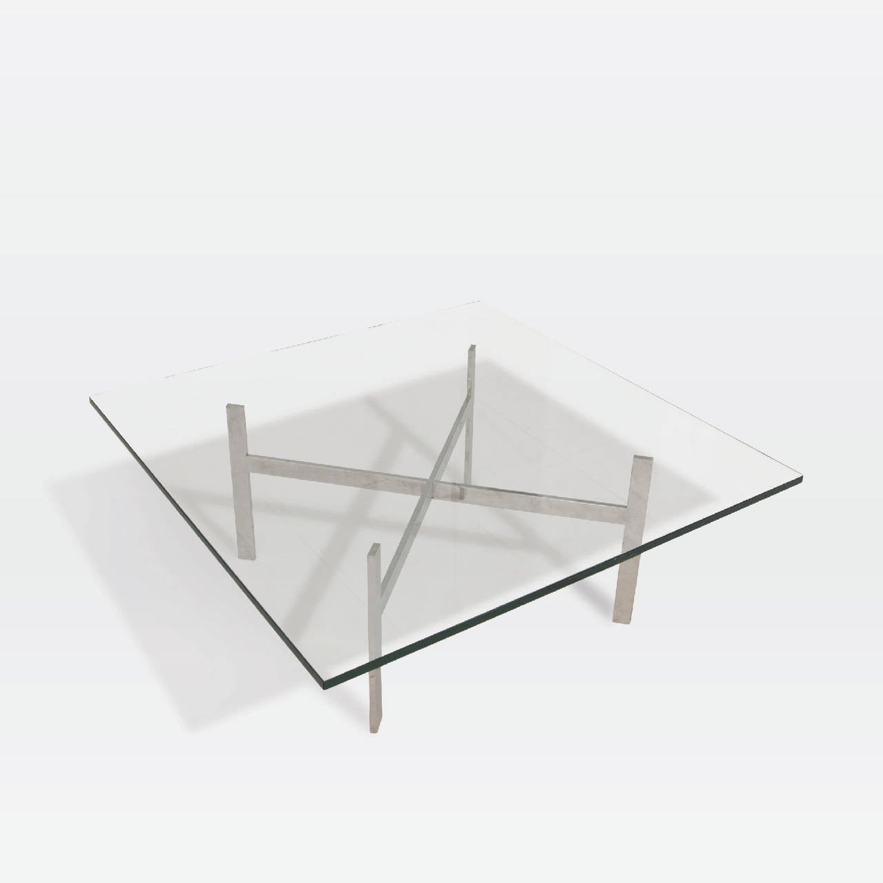 Square glass tabletop with chrome X braced base.