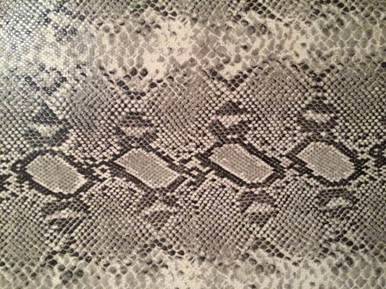 David Hicks solid wood Parsons table wrapped in python print, circa 1970.