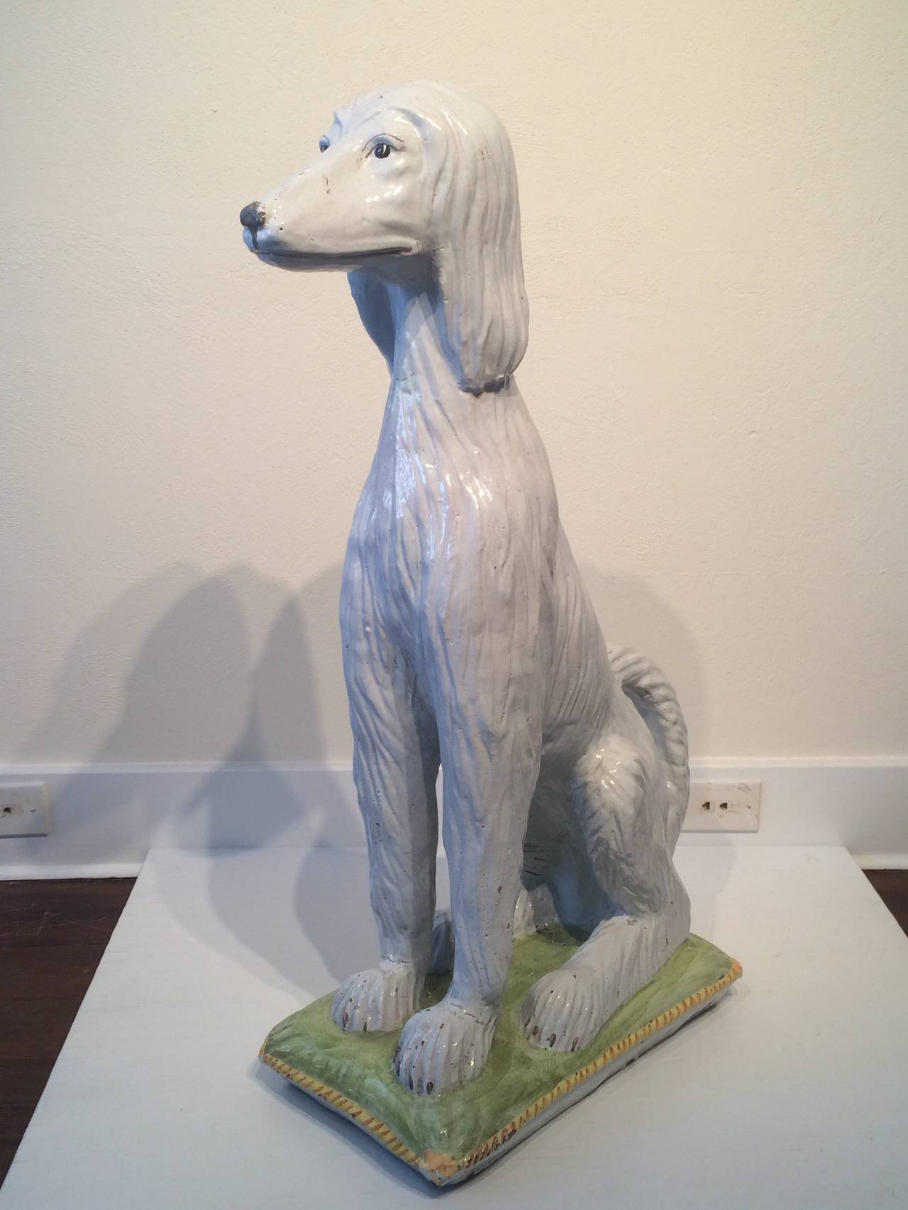 Life-size Afghan hound seated on cushion; dog sculpture
Glazed and painted ceramic,
Italy, 1950s.
