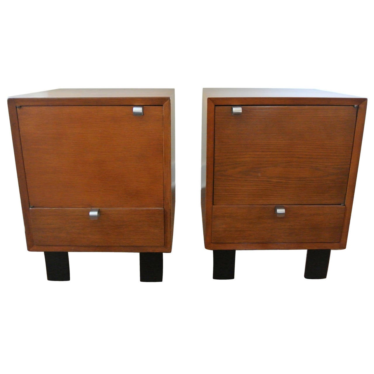 Early and original George Nelson for Herman Miller end tables/ nightstands, Model 4617, circa 1947.  Fully restored, these chests feature combed oak, lacquered wood feet, and aluminium pulls.

Literature: 
-George Nelson: Architect, Writer,