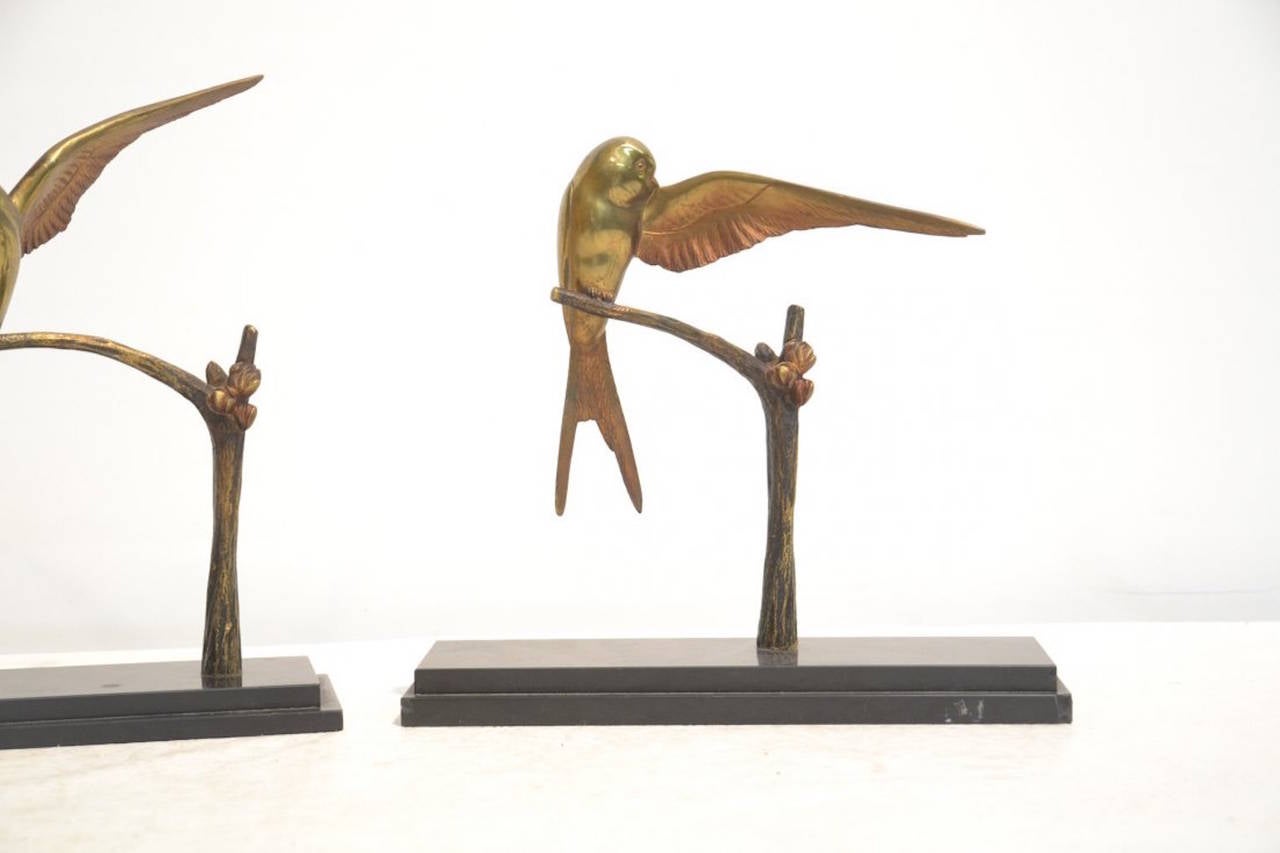 A pair of patinated bronze swallow sculptures mounted on marble bases by Georges H. Laurent.
France, circa 1930.

Dimensions: taller 11 1/2
