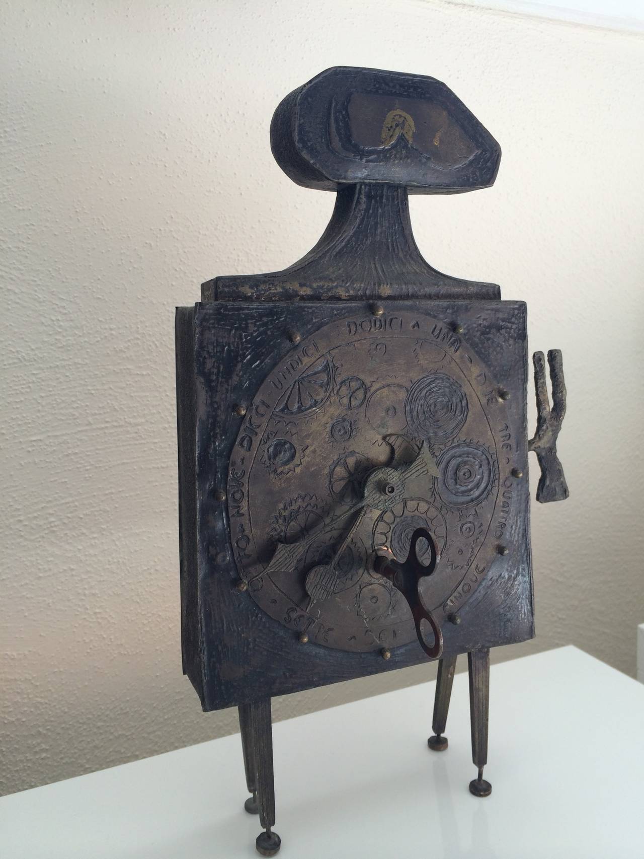 Clock sculptures were some of Lorenzo Burchiellaro’s earliest works. This figural bronze sculpture features an abstract design with stylized clock face, raised on four bent legs. This particular piece resembles the work of Modern British artist,