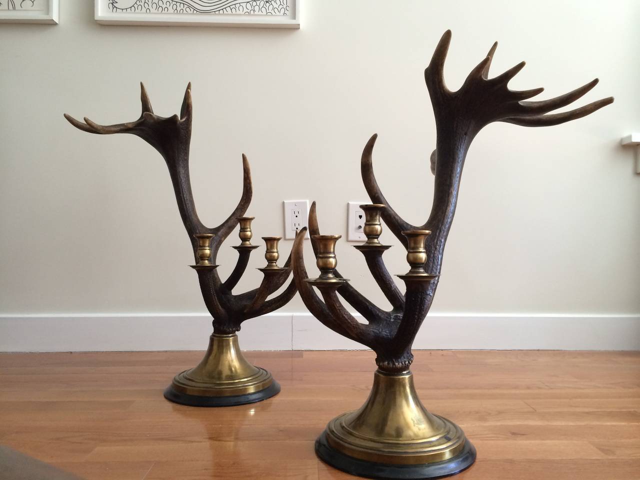 Three-light Scottish red deer antler candlesticks (In the Balmoral style) designed and manufactured by Anthony Redmile, London, circa 1980. 

Brass with ebonized base.