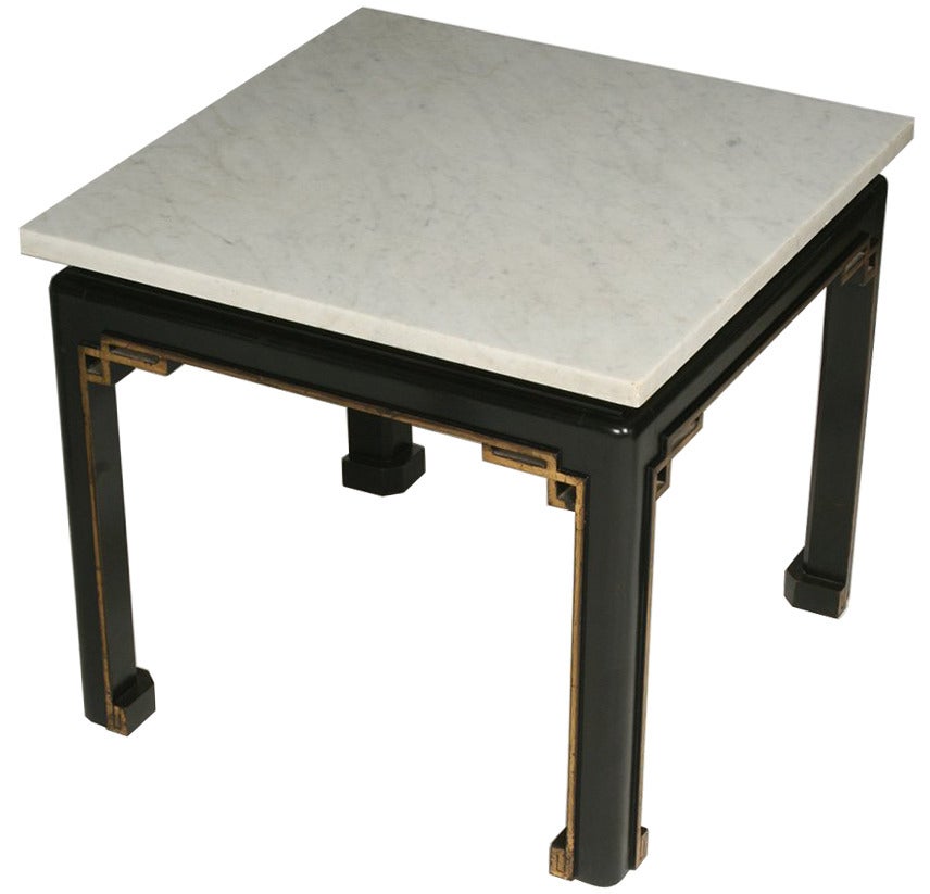 Pair of French cocktail or coffee tables in the chinoiserie style. Marble top above a black lacquer base with gilt fretwork and trim. 

Dimensions: Height 19