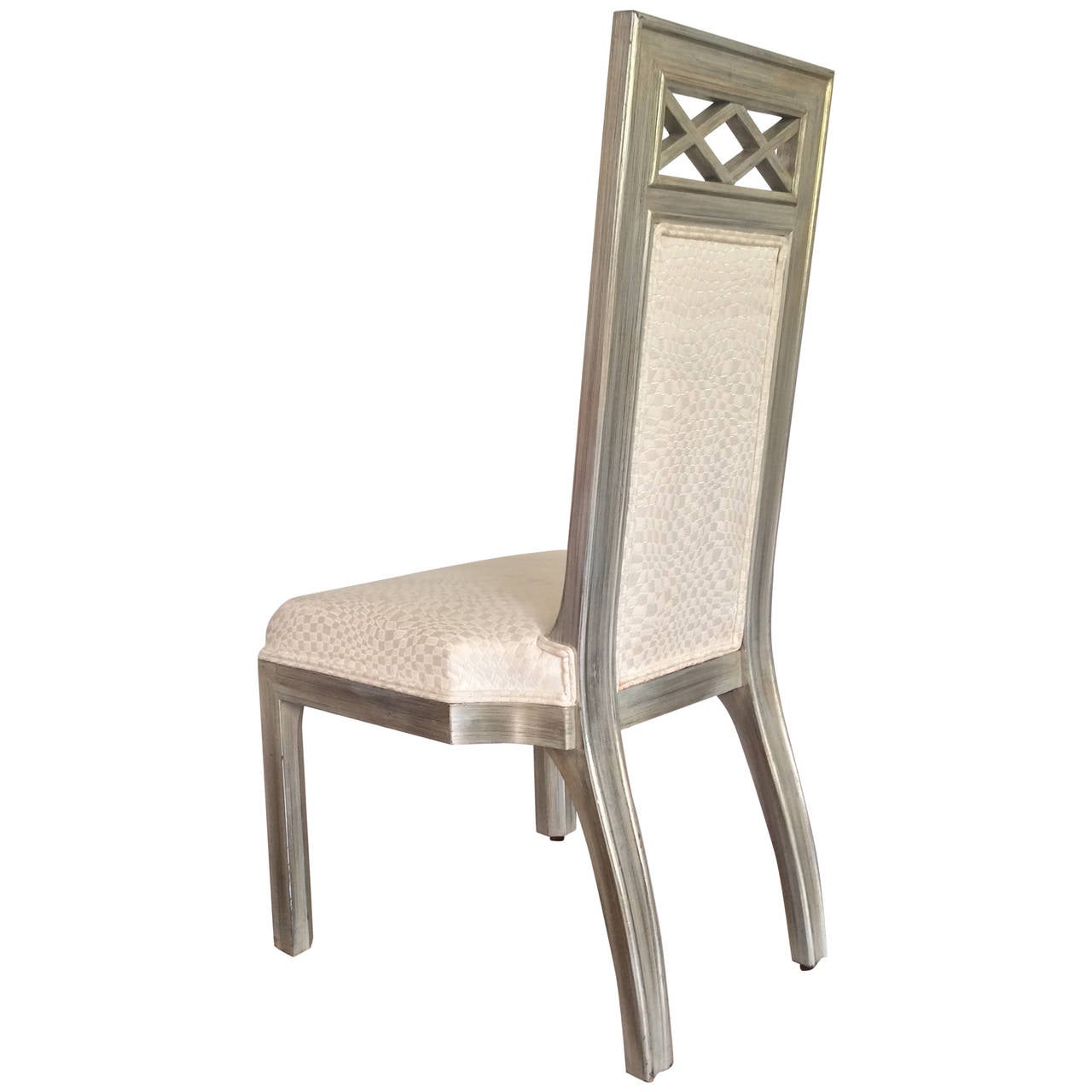 A James Mont wood and silver leaf occasional chair. 

Dimensions: 40" H x (18" seat height) x 19" W x 22" D.