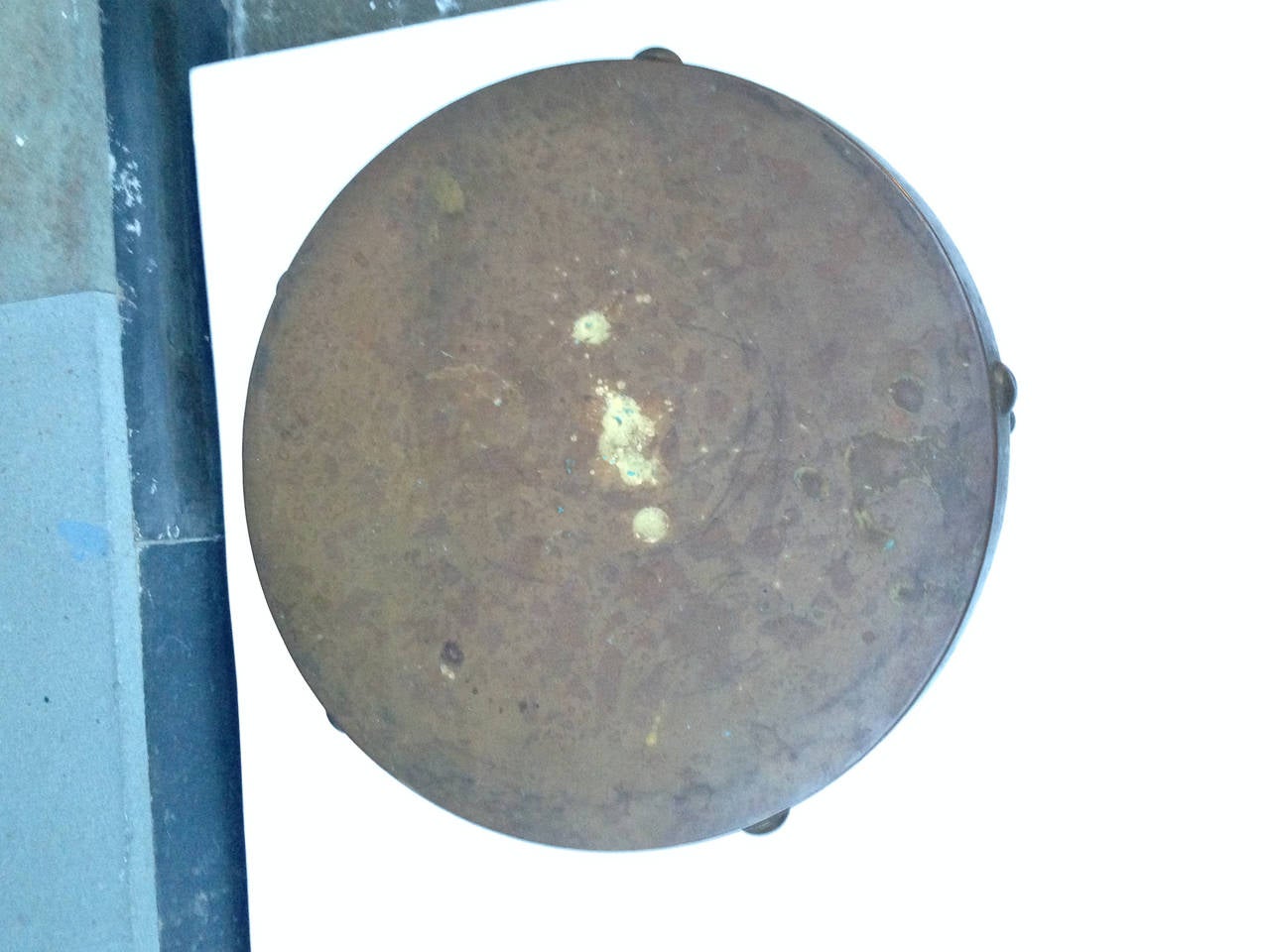 This vintage brass drum style side table maintains its original patina.  The underside is marked 