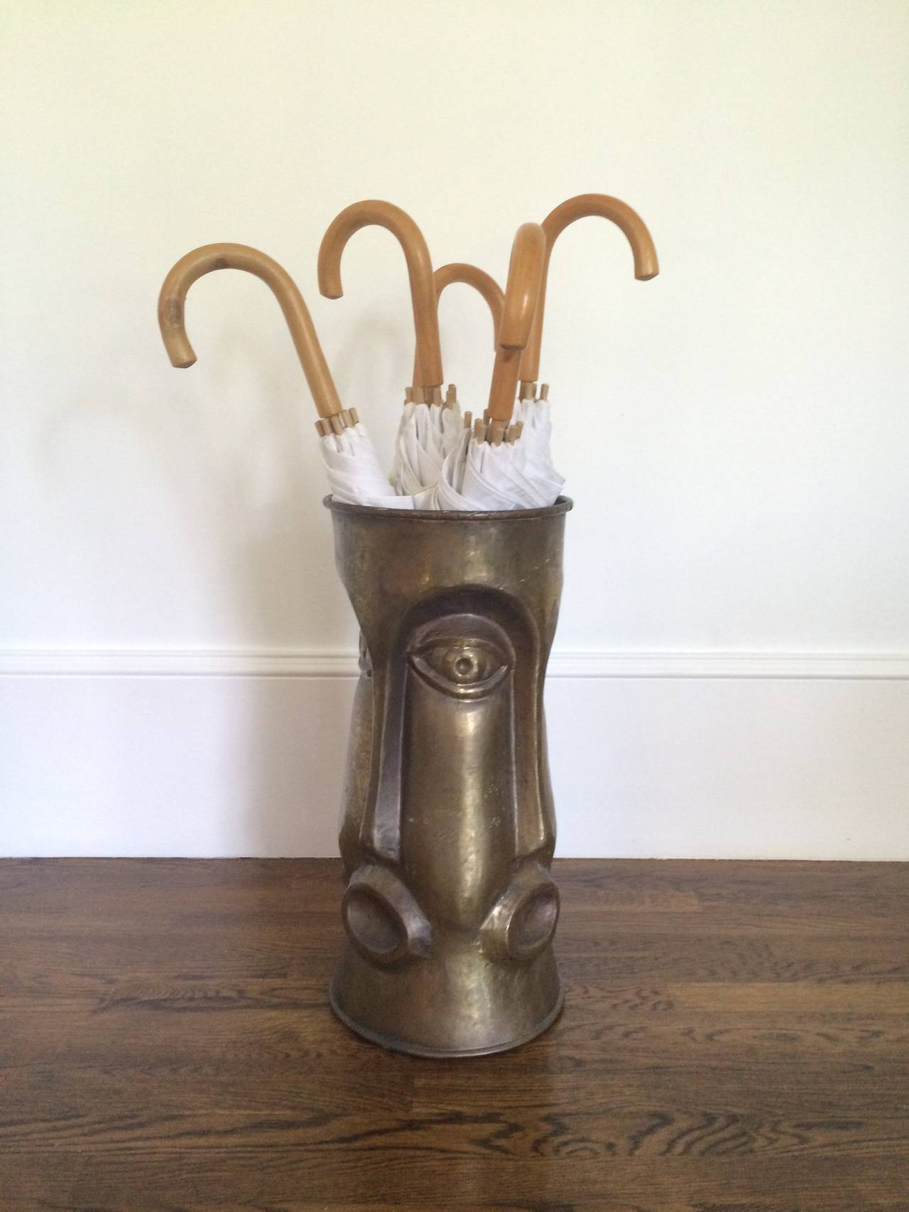 Mid-Century Modern Italian Brass Umbrella Stand with Repeating Face Motif, 1960's.