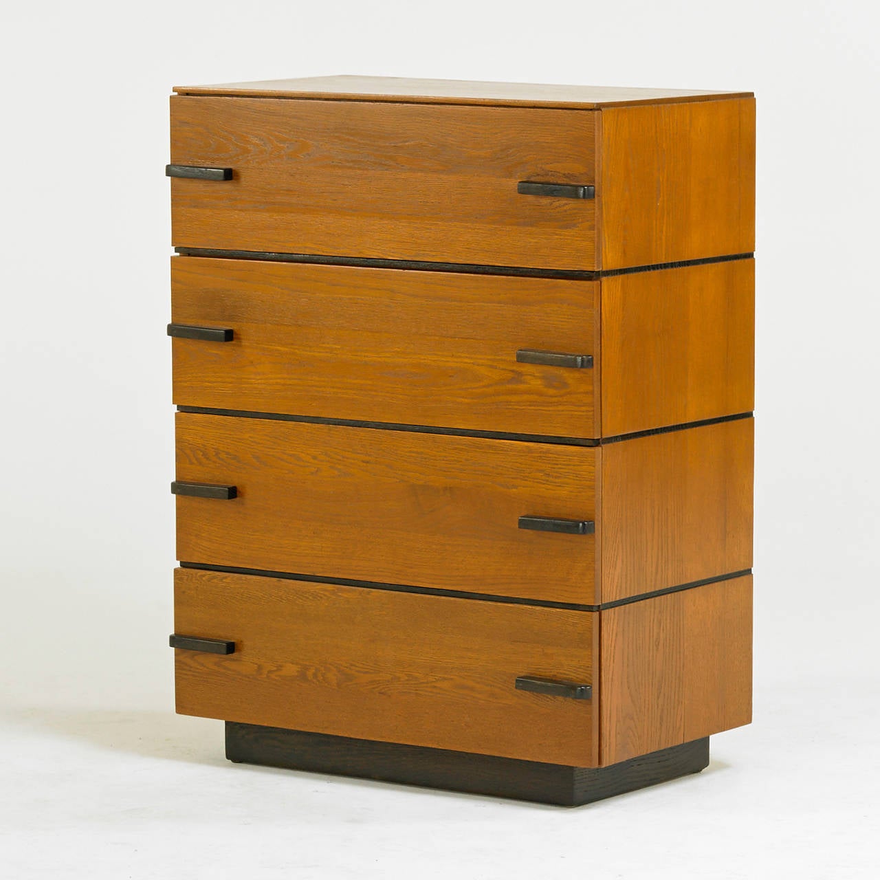 A four-drawer chest designed by Gilbert Rohde and manufactured by Kroehler. Oak with ebonized oak detail, foil label, USA, 1930s. Excellent condition.