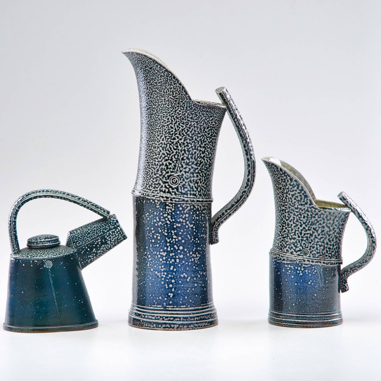 Two salt glazed pitchers and teapot with applied handles and incised decoration, Wales, second half of the 20th century, tallest 15".

Missing lid to teapot.

Born 1942, Edgware, Middlesex. 

1958-1963 Harrow School of Art,