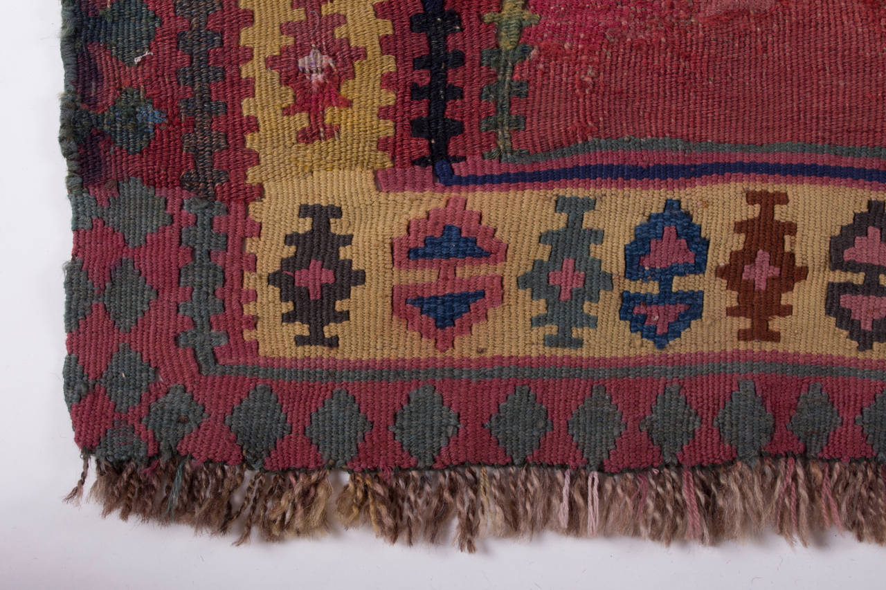 A unusual Persian, possibly Kurdish Bidjar Kilim, in harmonic blue, yellow and red colors. 

The minimal change of the yellow colour at the level of the lower and upper border might suggest that the kelim was longer (and symmetric) originally and
