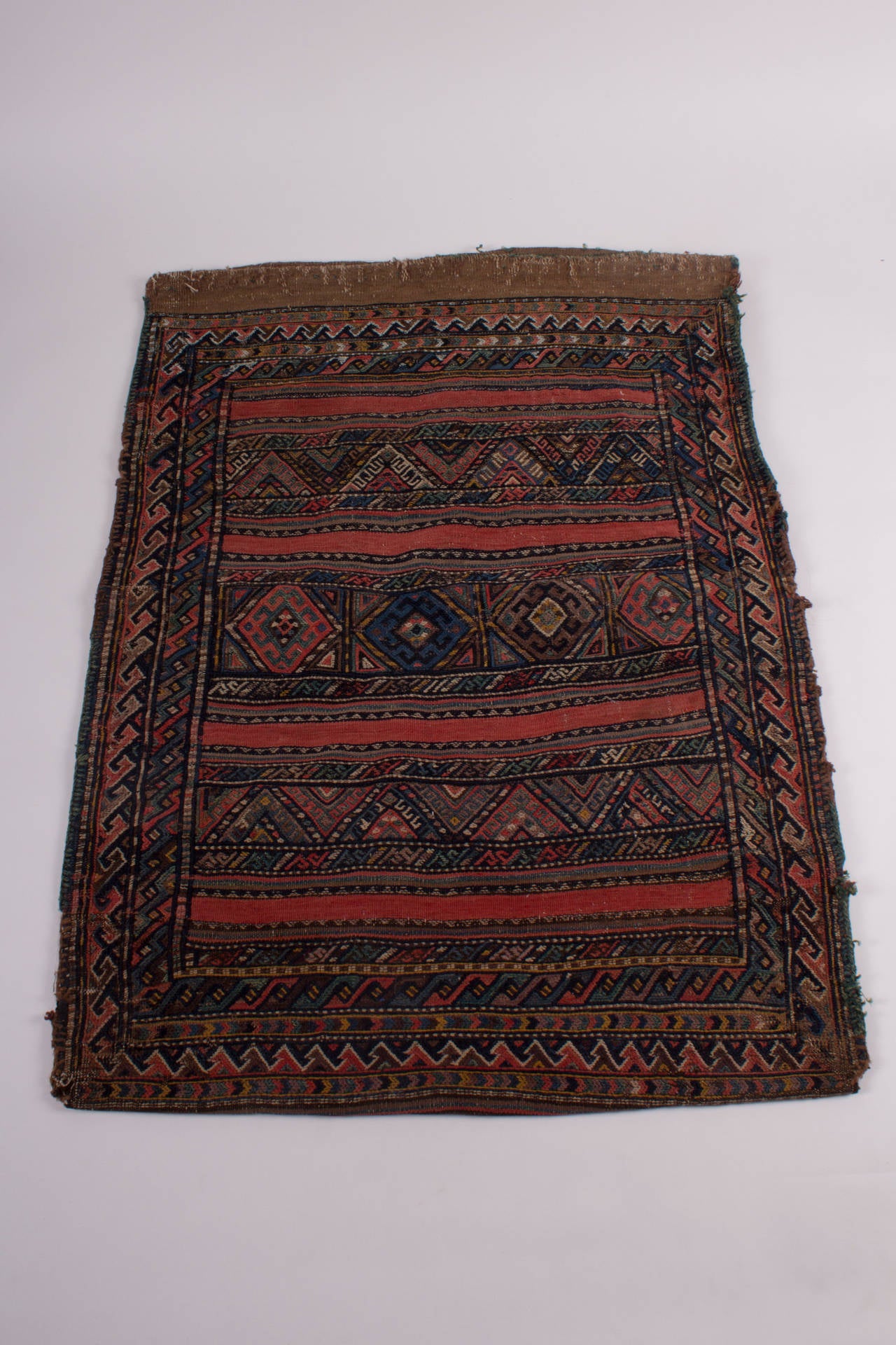 An antique (about 1900), grain sack from Turkmenistan, probably Shahsavan nomads. A colorful, complete Piece with two different kinds of “running dog” borders, also fine, and different kinds of embroideries. 

With bright and brilliant colors, all