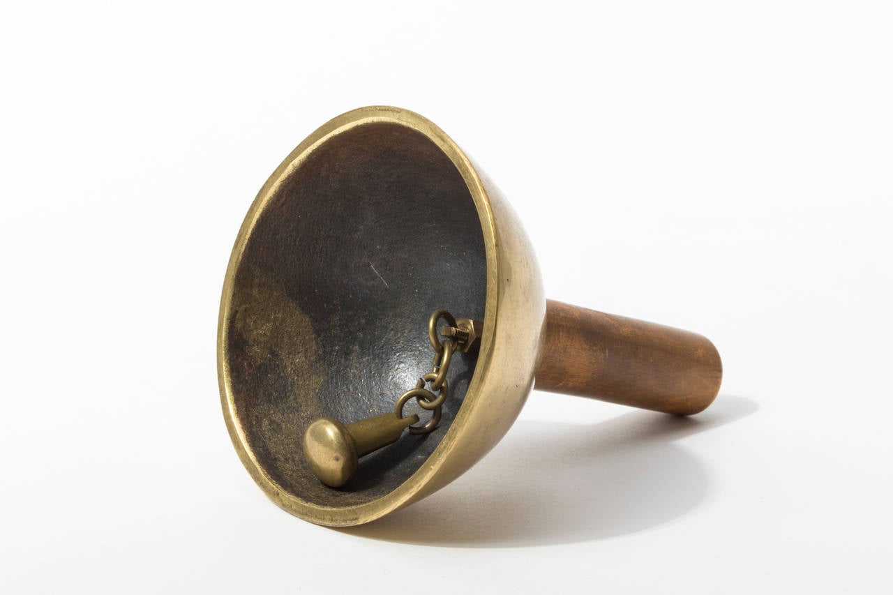 This striking object was designed and manufactured by Carl Auböck at his workshop in Vienna.

The patinated inside of the bell and the assembly of the bell ringer show the quality and craftsmanship the designs are known for.