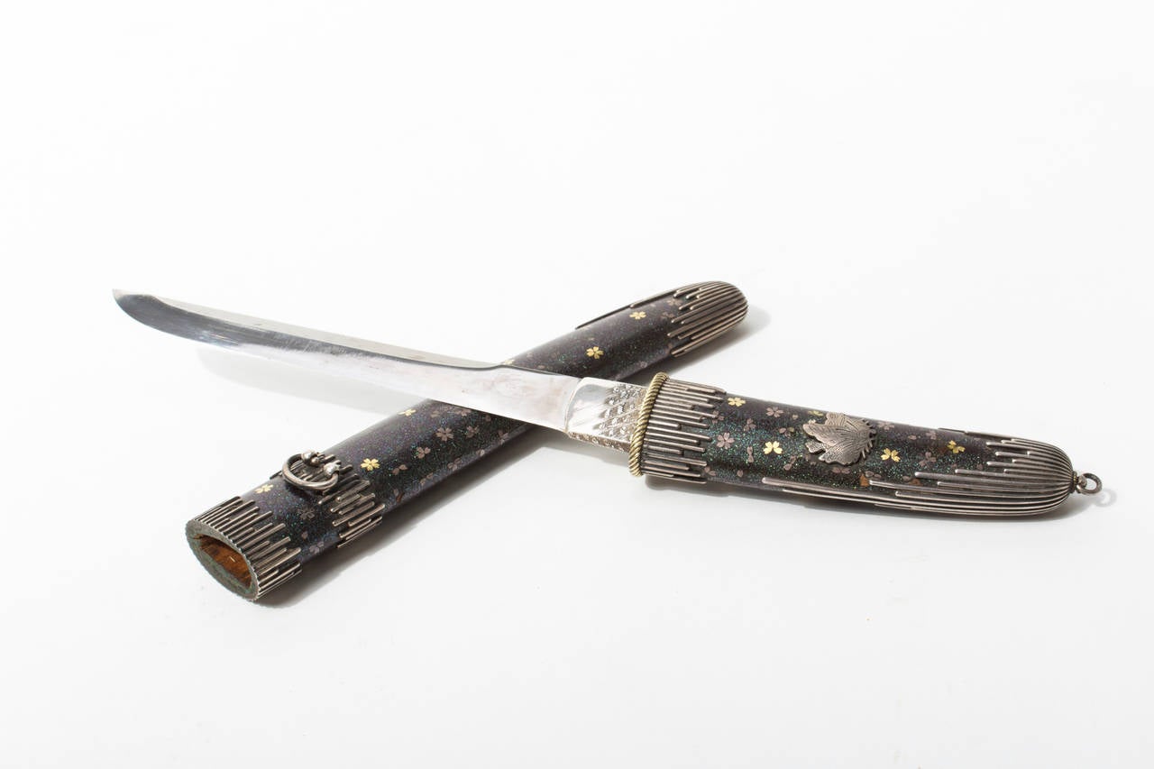 The presented dagger, a so called Tanto or Aikuchi has extensive Maki-e inlay works on the shaft and saya (scabbard) and decoratively placed habaki (silver mountings.

The blade is in perfect condition and bears unidentifiable signs at the shaft.