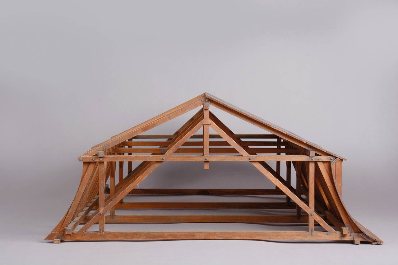 The beech wood model was manufactured during the second half of the 19th century for didactical purposes at engineer’s colleges and universities. The lightweight mansard attic with two dormers is half covered with wood, imitating the roof sheeting.
