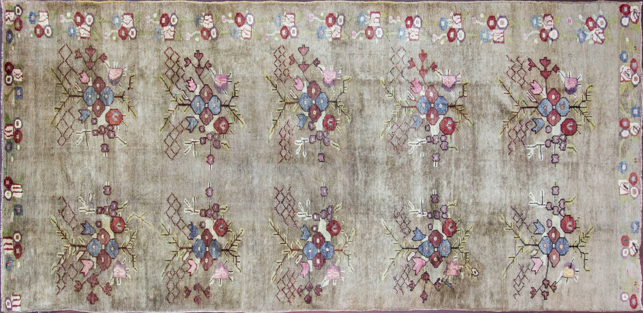 An absolutely amazing handwoven Turkish Oushak carpet with unusual repeated boukuetof flowers.
The colors are muted and highly stylized floral accent. 
originally purchased from a nice west cost collection that I consider it a great find.

 Ushak
