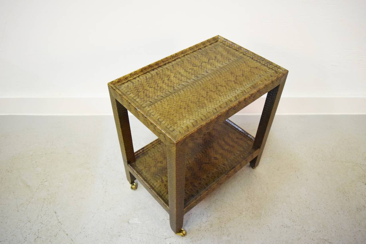 Karl Springer snakeskin telephone table. Petite telephone table wrapped in python snakeskin. Item signed and dated.