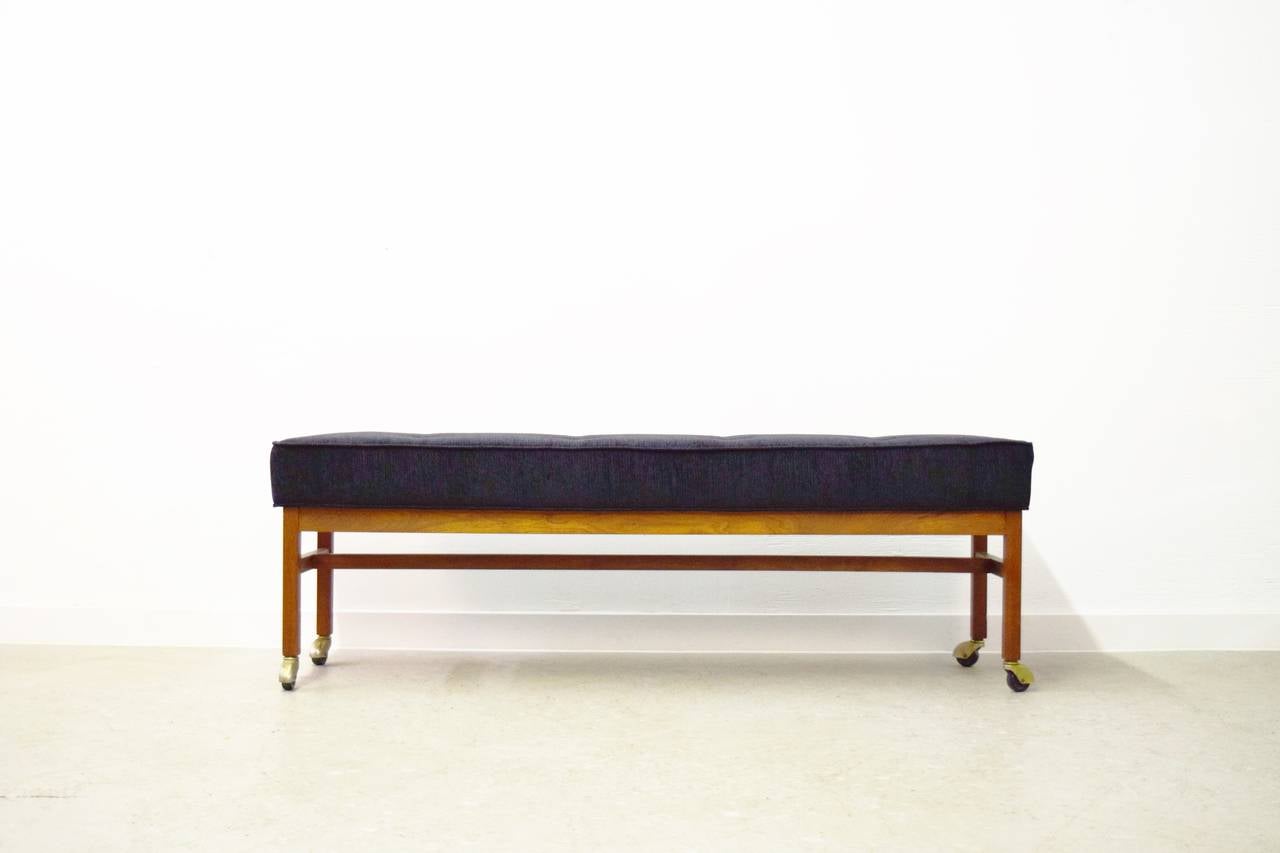 Mid-Century Tufted Bench on casters.  Newly upholstered in black Chenille fabric.