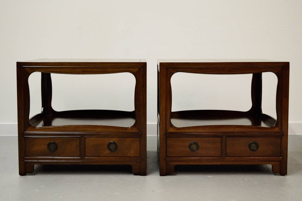 Pair of nightstands by Baker Furniture Company, lower pull-out drawers with finished back.