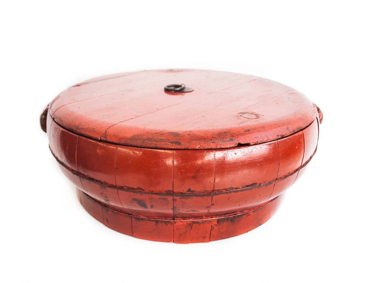 Big flat wooden box with lid, in warm Chinese red colour. Lid has a metal ring. This is an old box from Zhejiang province, China.