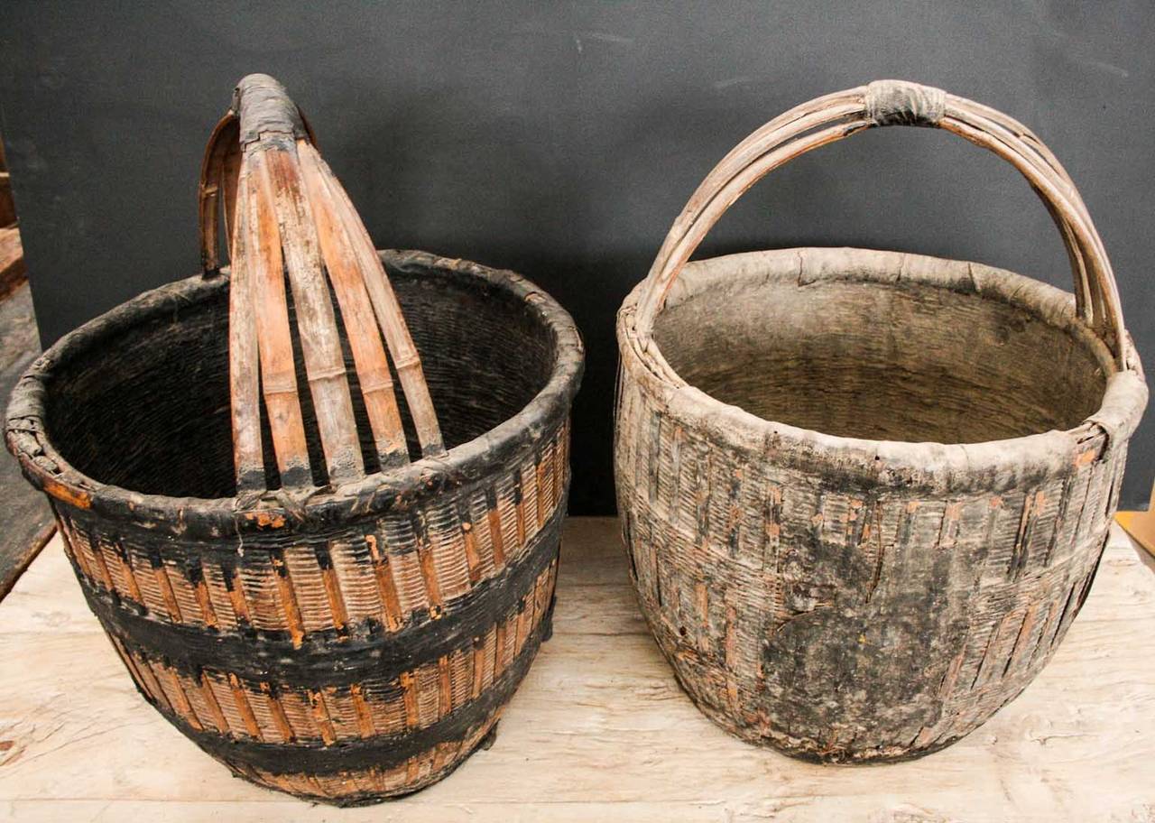 Old large round bamboo woven baskets from Shandong province, China. Left one is still orange and black coloured, the right one is more weathered. Only 2 pieces available.